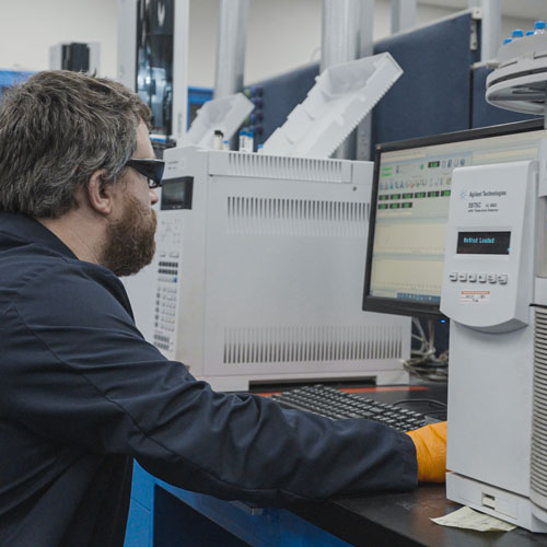 Heat Transfer Fluid Testing being performed by man on computer