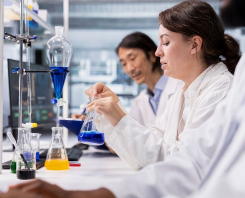 Lab workers prepping for chemical distillation work.