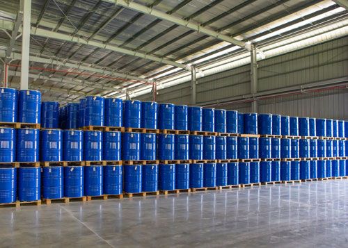 raw-material-sourcing-500 Rows of pallets of large blue drums.